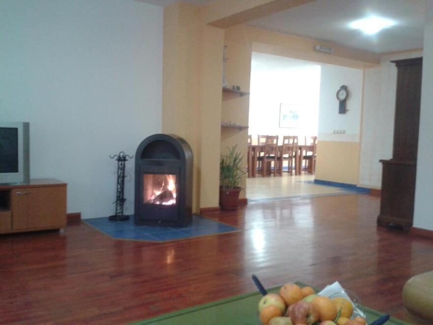 a living room with a fireplace and a bowl of fruit at B&B Nikki in Međugorje