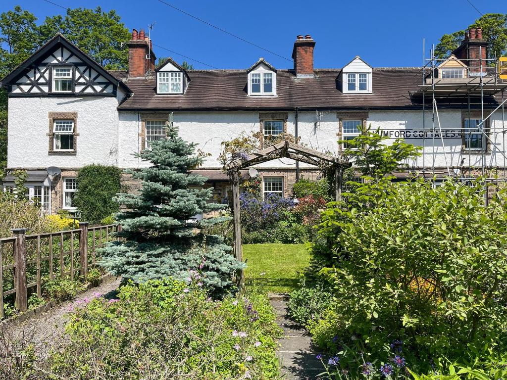 a large house with a garden in front of it at Puddle Duck Cottage in Bakewell