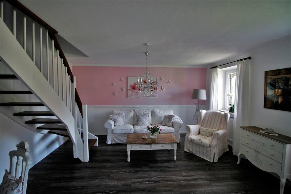a living room with a couch and chairs and a staircase at Ferienwohnung Heimatglück 2-3 Personen 65qm WLAN in Breitbrunn am Chiemsee