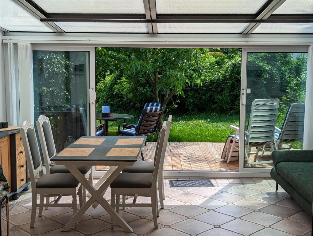 a patio with a table and chairs and a couch at Garden View Apartment in Breitenbrunn