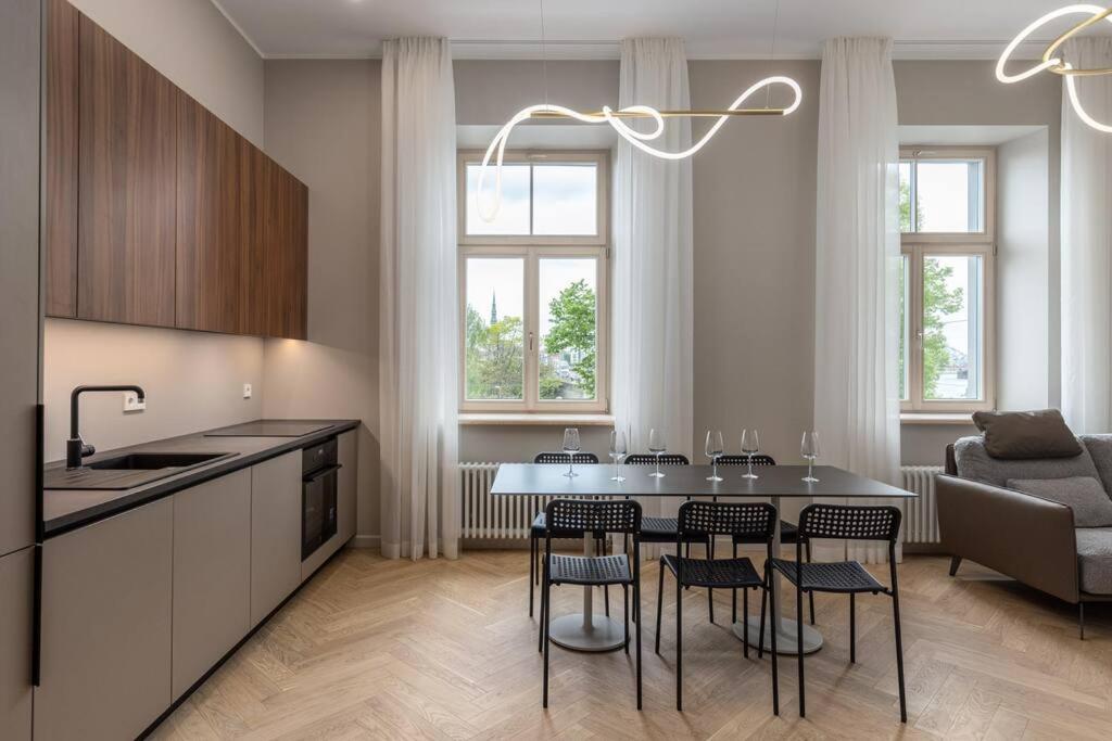 a kitchen and dining room with a table and chairs at OldTown&River View Hoffmann A4 in Rīga