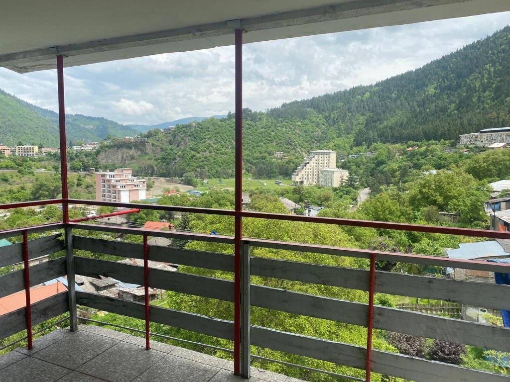 a view of a city from a balcony at Мансарда с верандой in Borjomi