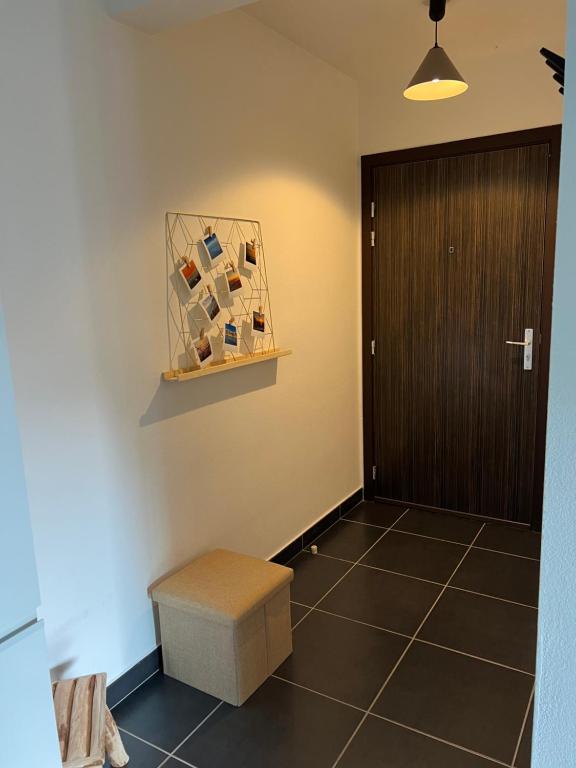 a hallway with a door and a stool and a room at T2 avec très grande terrasse in Bastia