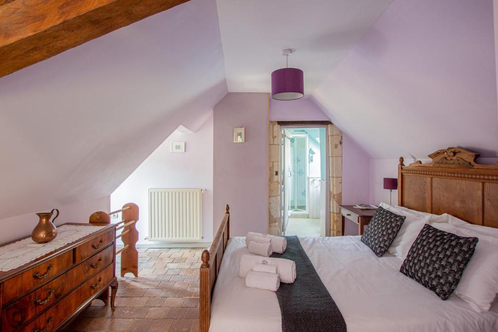 a bedroom with a large white bed and a desk at ROCHE-LOIRE in Le Thoureil