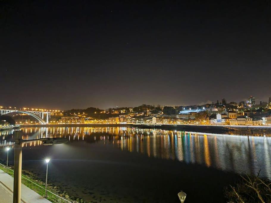 a river at night with a city and a bridge at Central duplex apartment-full view of Douro river in Vila Nova de Gaia