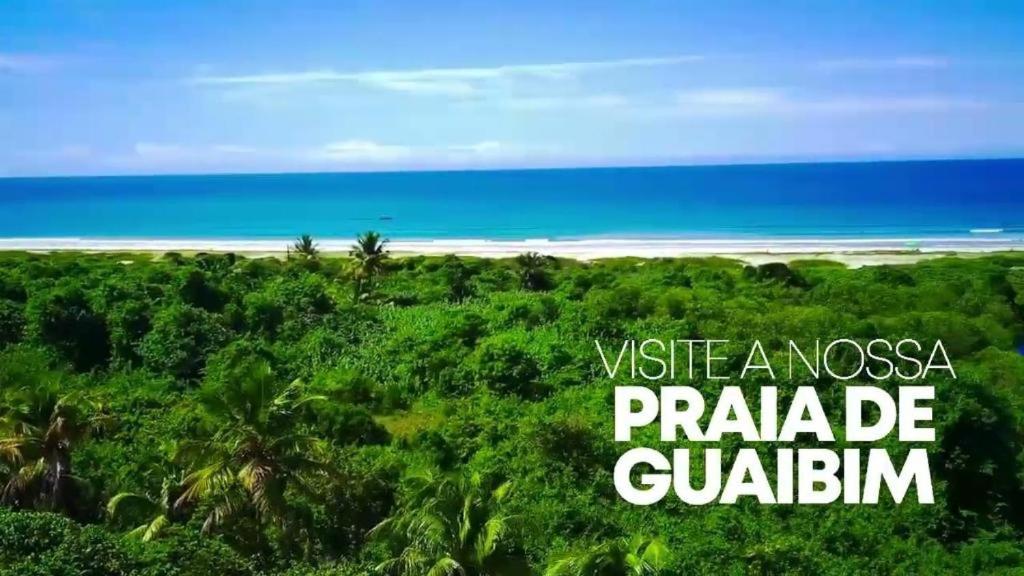 a view of a beach with the words use a nosoya paradise guadalim at Bimba Chalés Pé na Areia - Guaibim-Ba in Guaibim