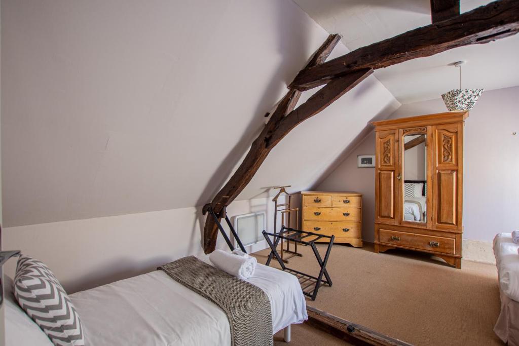 a bedroom with a bed and a dresser in a attic at ROCHE-LOIRE in Le Thoureil