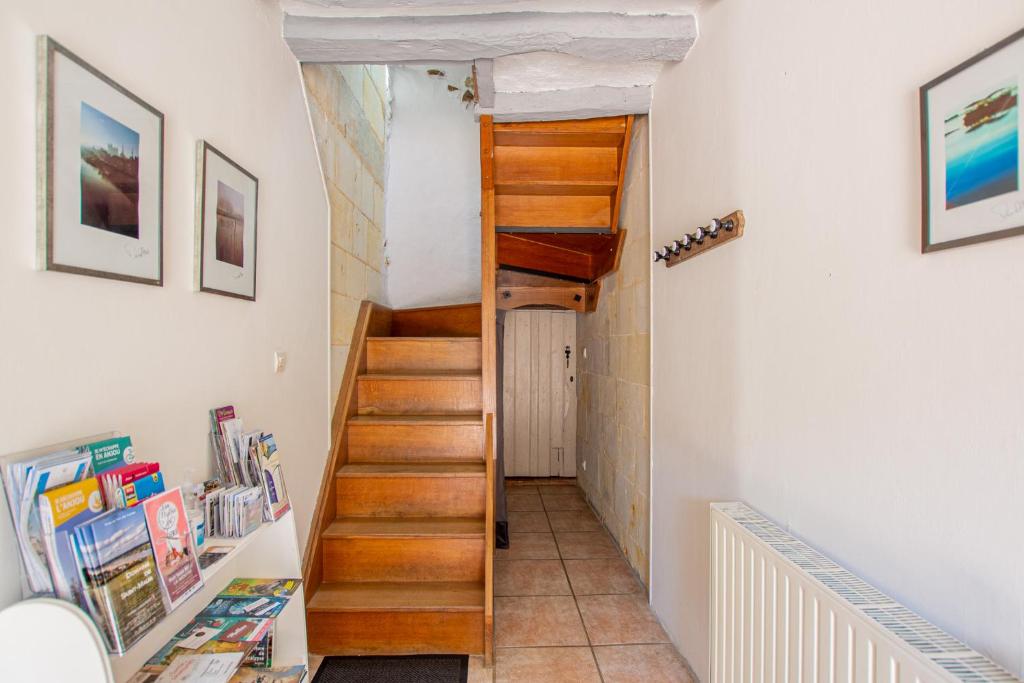 a staircase in a home with white walls and wooden stairs at ROCHE-LOIRE in Le Thoureil