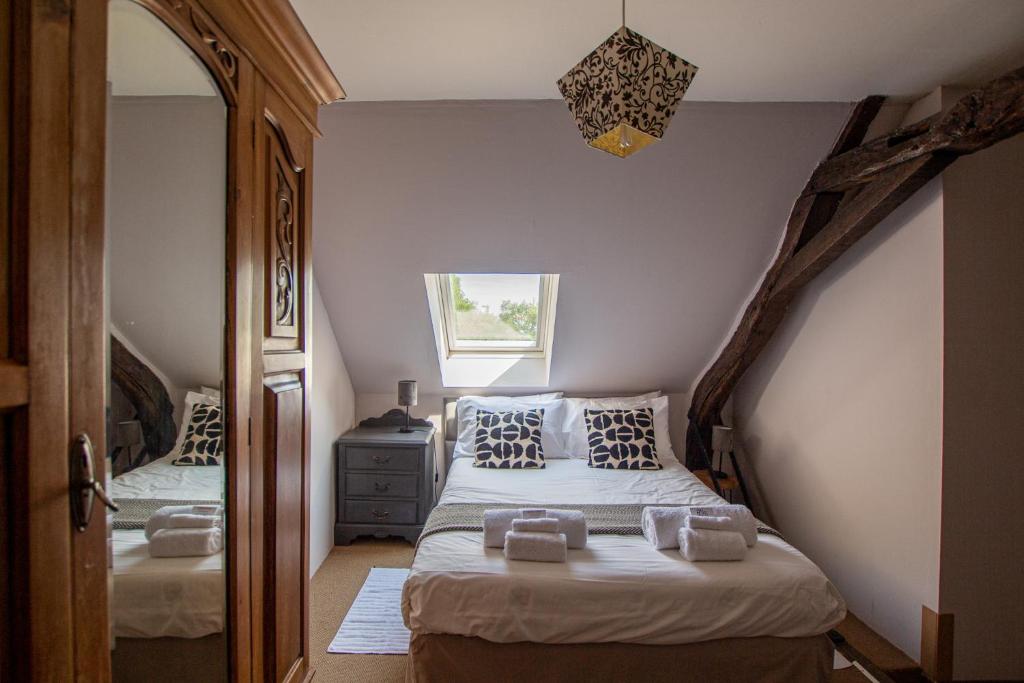 a bedroom with two beds and a mirror at ROCHE-LOIRE in Le Thoureil