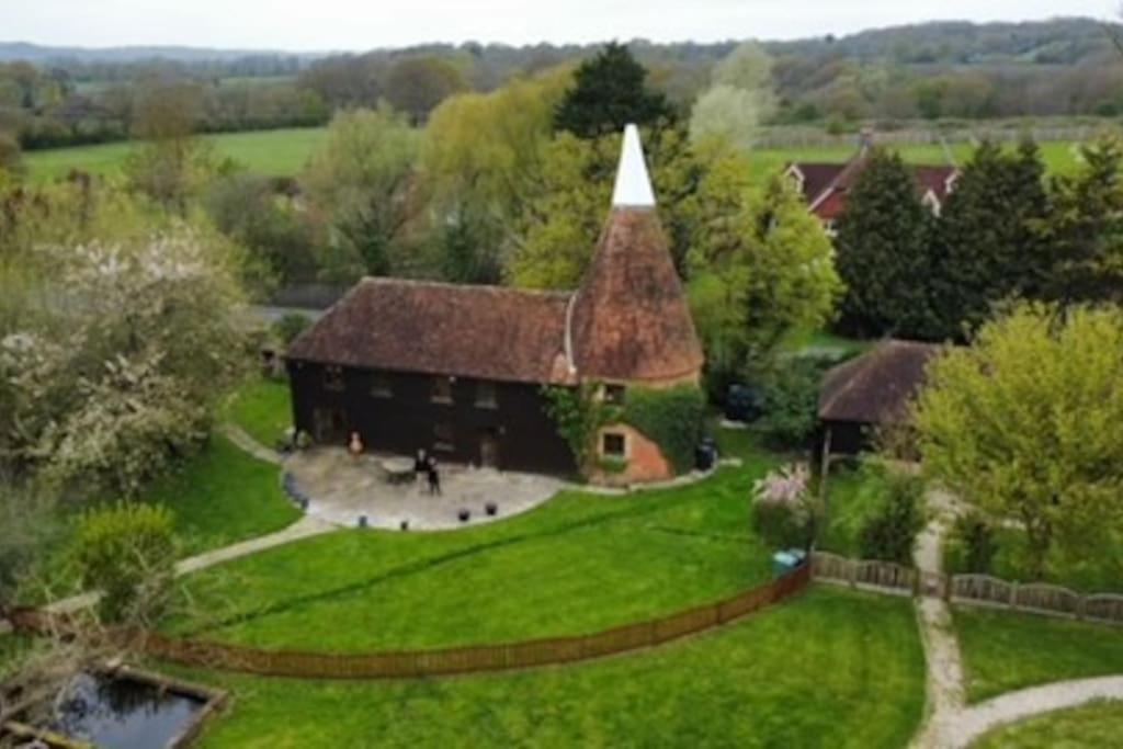 an aerial view of a house with a large yard at Charming Bluebell cottage - lake views nr Tenterden & Rye in Rolvenden