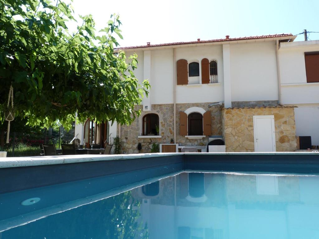 eine Villa mit einem Pool vor einem Haus in der Unterkunft Superbe bas de Villa à 80m de la mer in La Seyne-sur-Mer