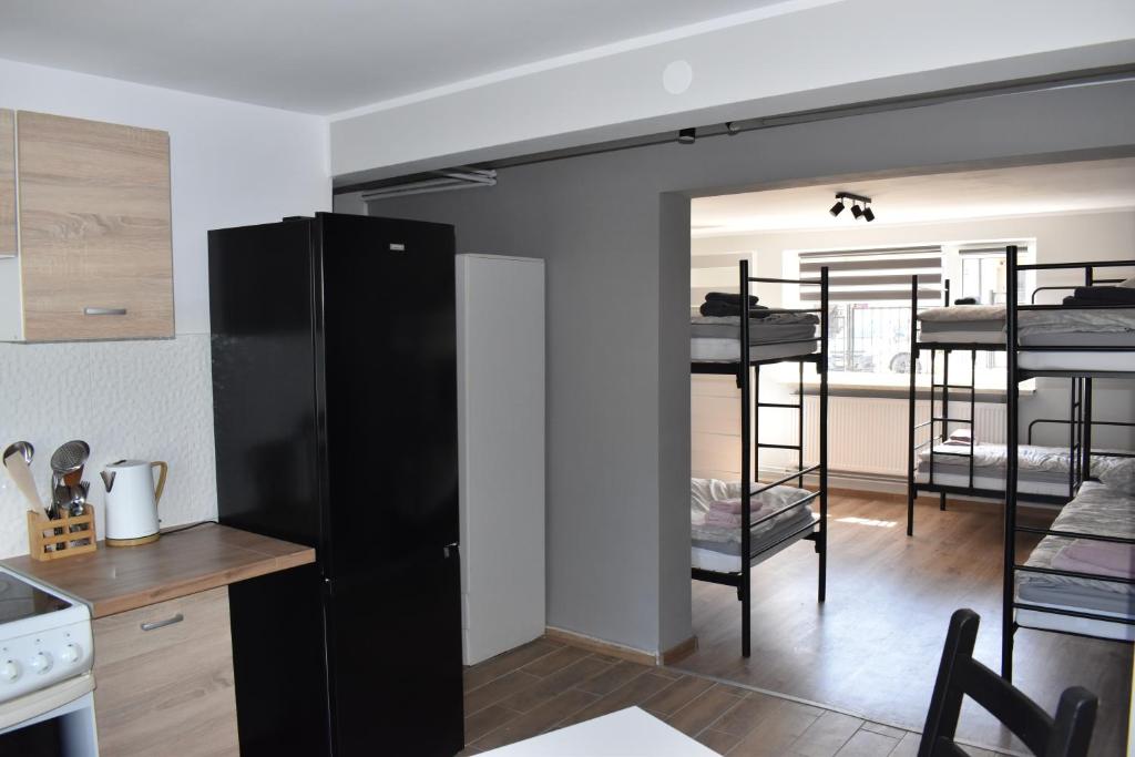 a kitchen and living room with bunk beds at Apartament Zacisze in Iława