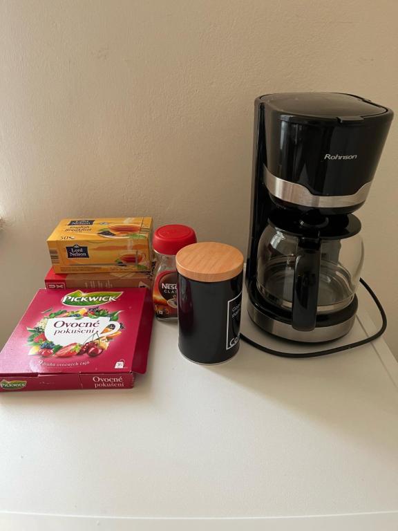 a coffee maker and a box on a counter at Apartmán Colette in Prague