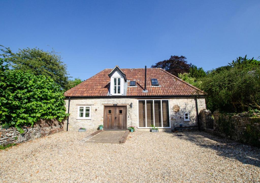 an old stone house with a large driveway at Ruth's in Charminster