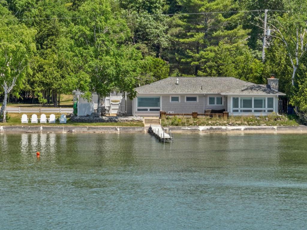 a house on the shore of a body of water at Cloud Nine on Crystal Lake in Beulah