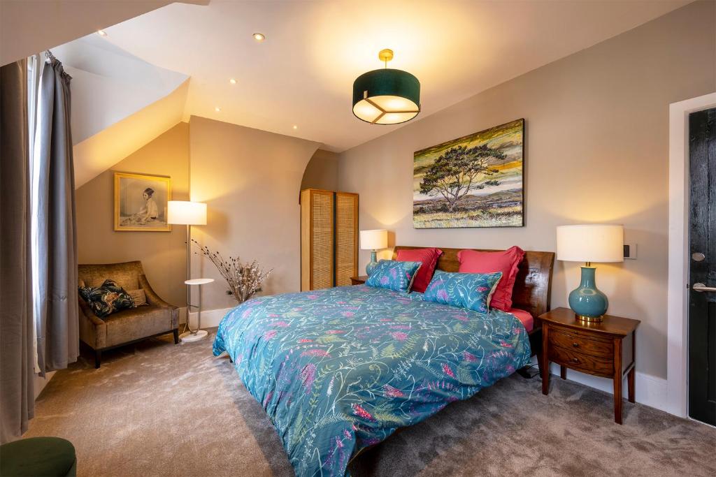 a bedroom with a bed with blue and red pillows at Luxury Central Home - Parking & EV point in Canterbury