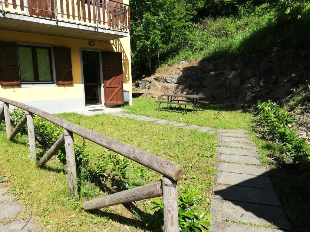 a wooden fence in front of a house at Ai piedi del Monte Cimone in Fiumalbo