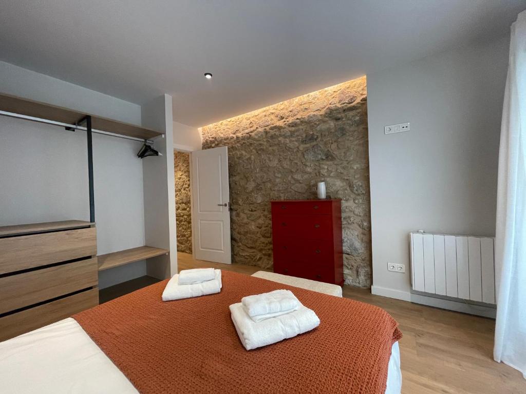 a bedroom with a bed with two towels on it at housingcoruña SAN NICOLAS 27 in A Coruña