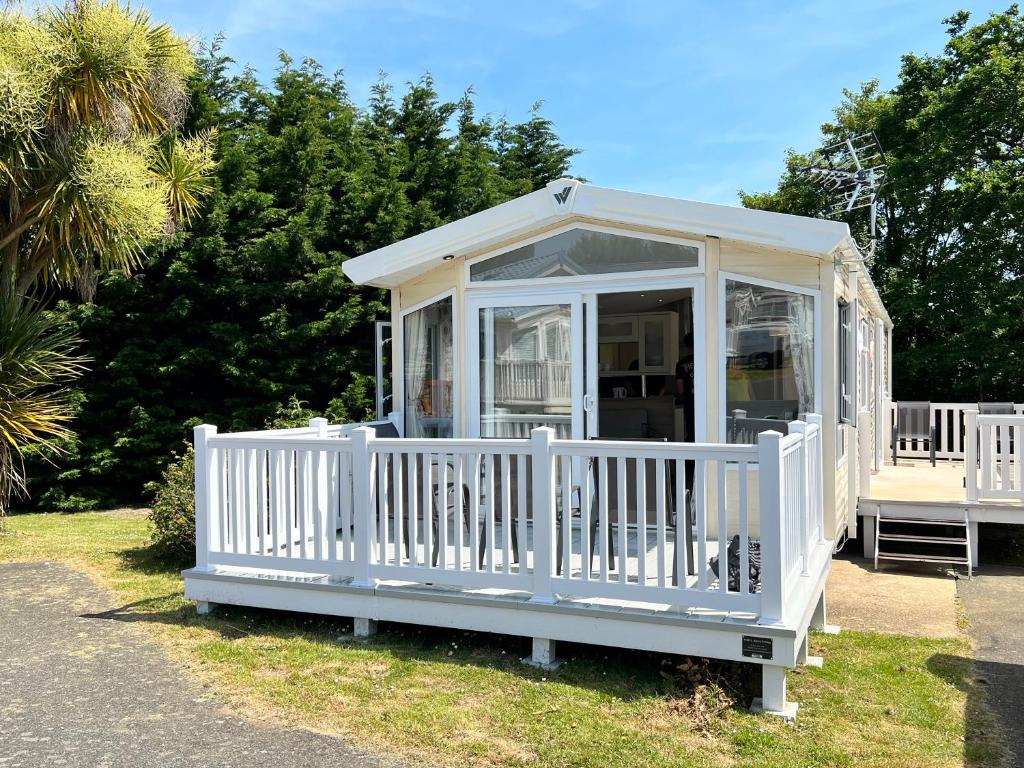 a white gazebo with a white fence at 3 Bedroom Caravan LG34, Lower Hyde, Shanklin in Shanklin