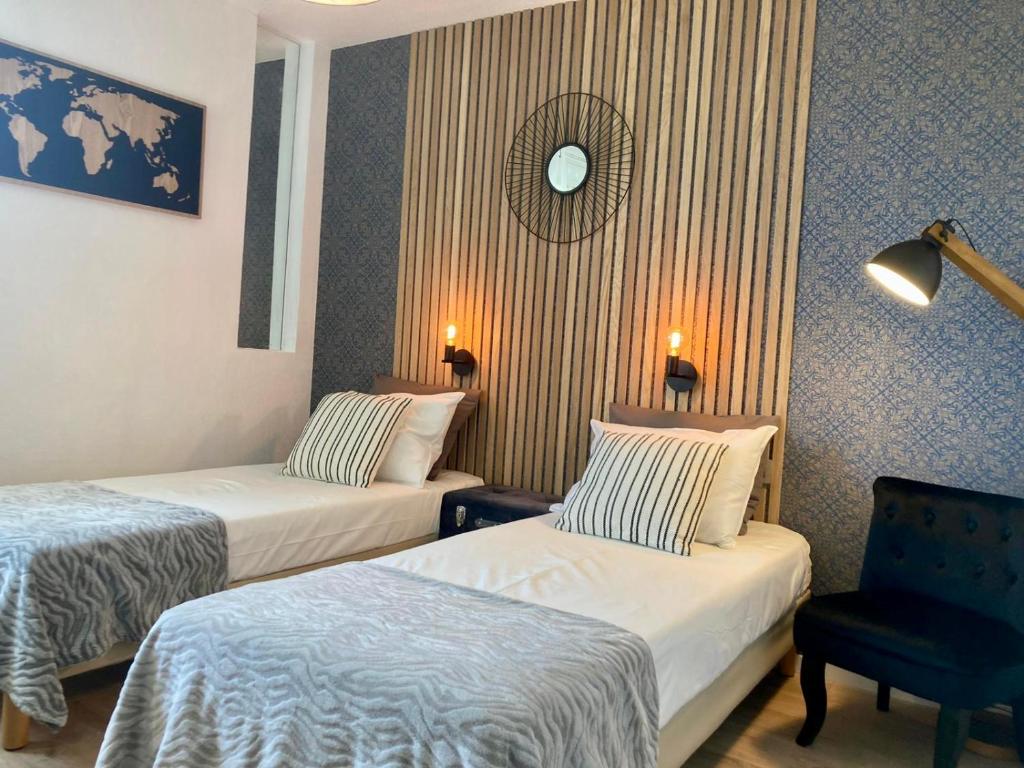 une chambre d'hôtel avec deux lits et une chaise dans l'établissement Appart'Hotel - Gare TGV - Courtine - Confluence - 407, à Avignon