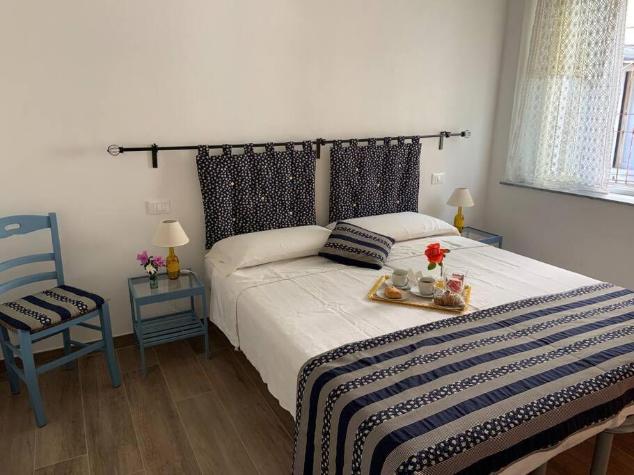 a bedroom with a bed with a tray of food on it at Casa in pietra in antico borgo vicino al centro in Pietrasanta