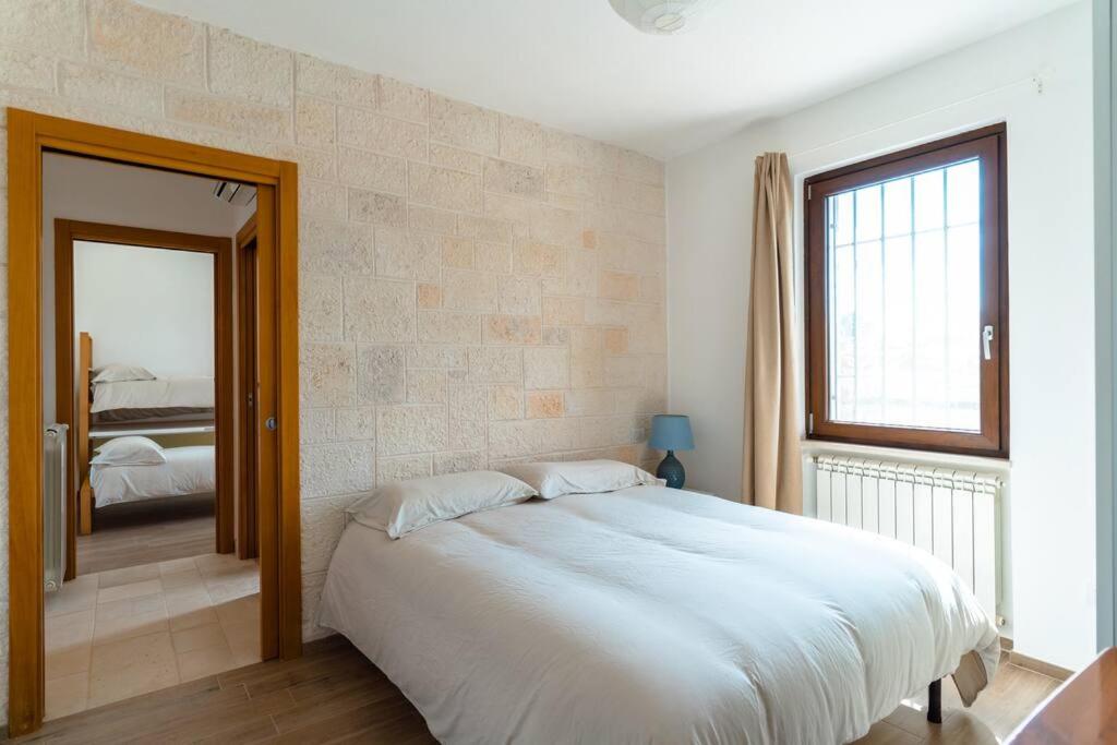 A bed or beds in a room at Trullo Caelum