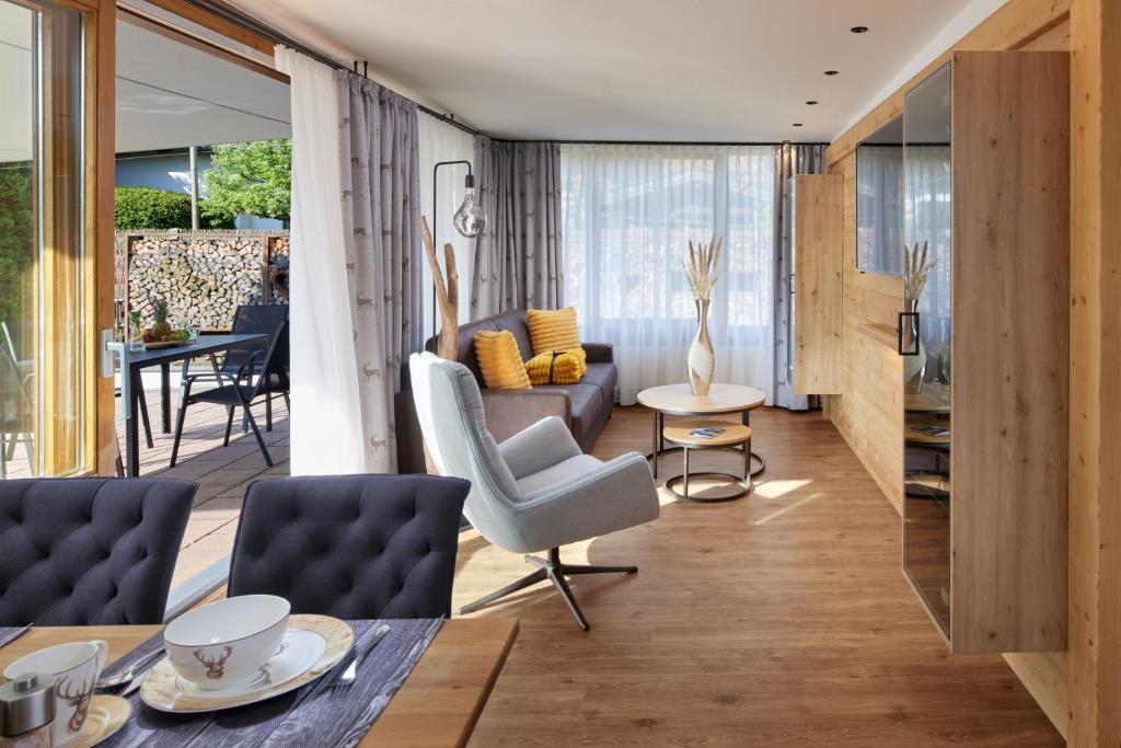 a living room with a couch and a table at Maximilian Appartements in Schwangau