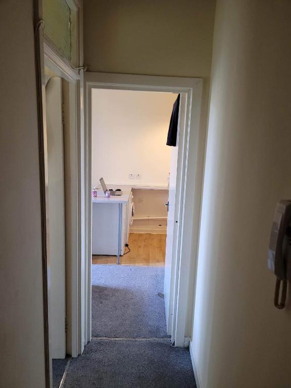 an open hallway with a desk in a room at Cosy Glasgow Southside Flat in Glasgow