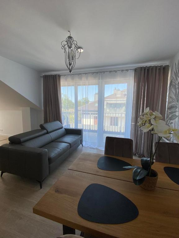 a living room with a couch and a table at NATURAvistaMARE I in Dziwnów