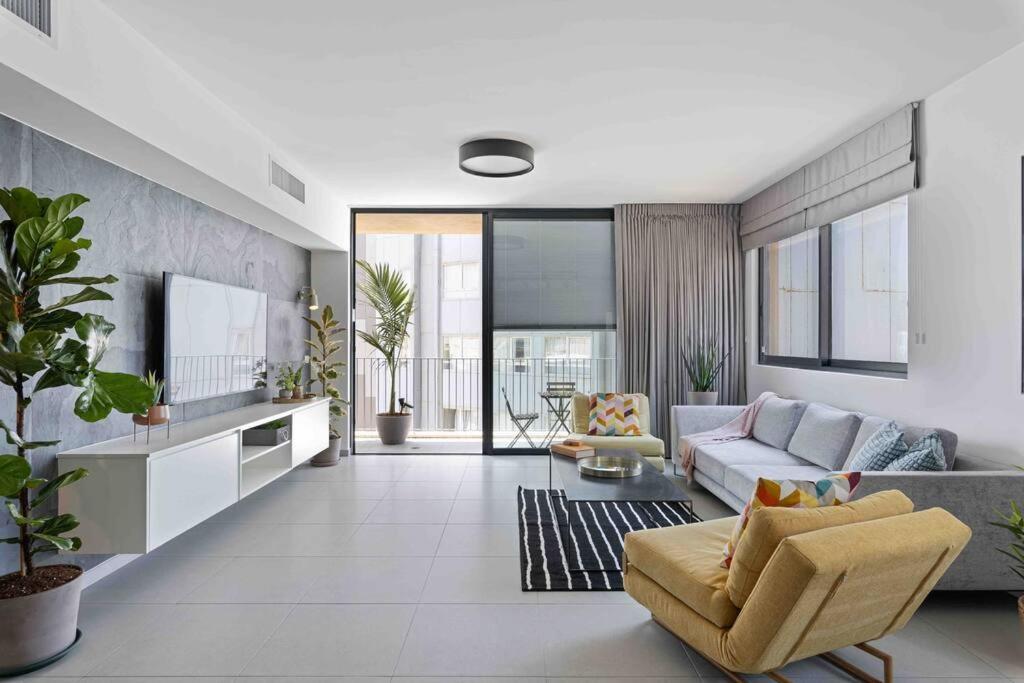 a living room with a couch and a tv at Ambassador apartment+parking in Tel Aviv