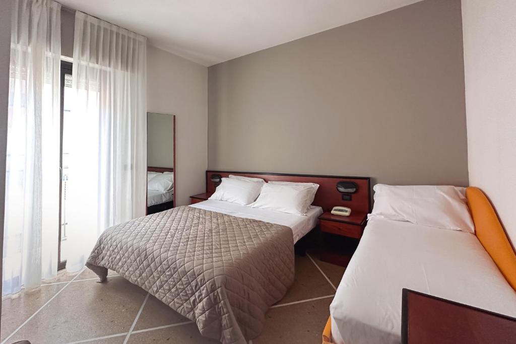 Postel nebo postele na pokoji v ubytování Lime Hotel
