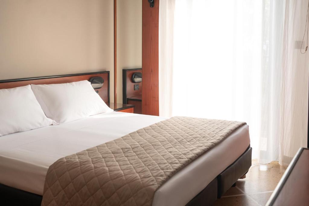Postel nebo postele na pokoji v ubytování Lime Hotel