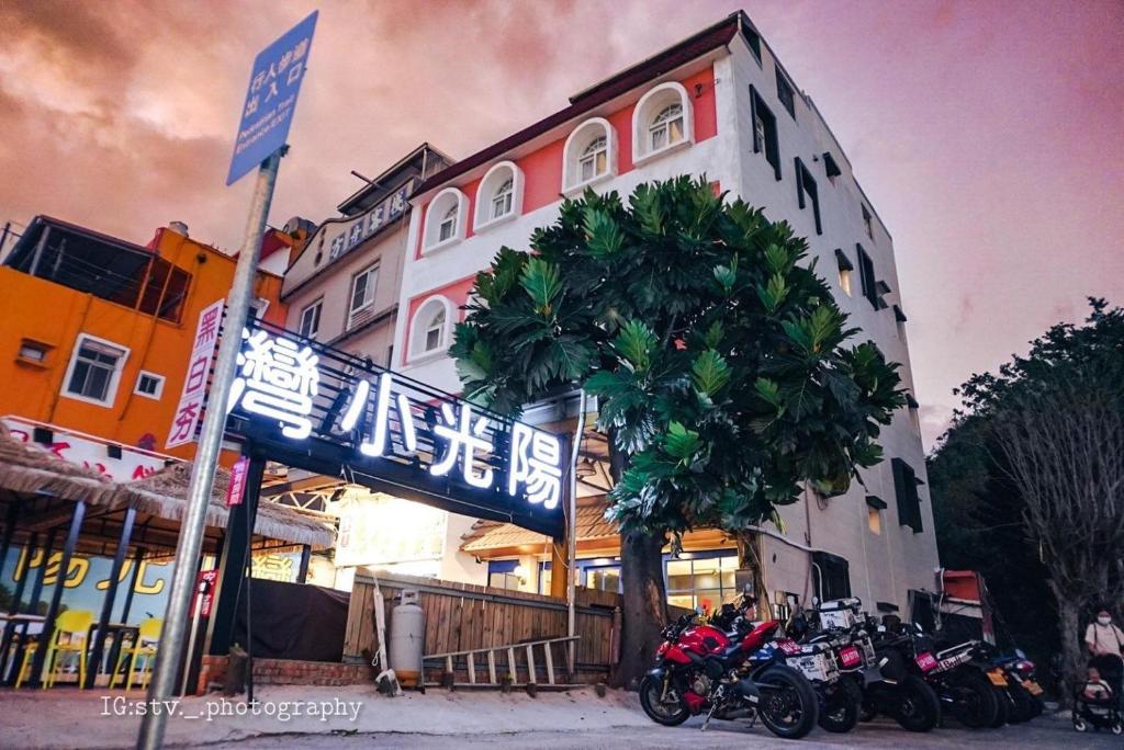 un grupo de motocicletas estacionadas frente a un edificio en 陽光小灣旅店 en Kenting