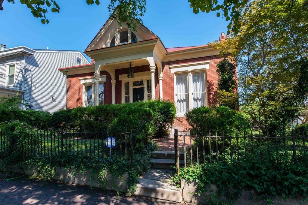 a brick house with a fence in front of it at Three Bedroom Apartment In Historic Nulu Property in Louisville