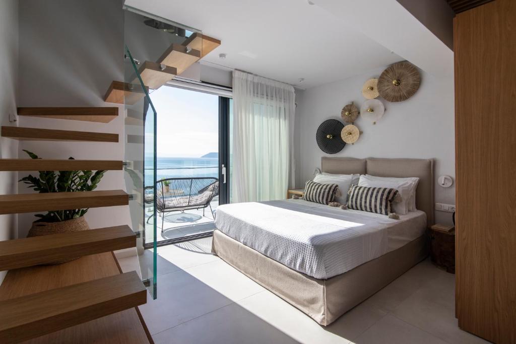 a bedroom with a bed and a glass staircase at Nōema Premium Stay in Neos Marmaras