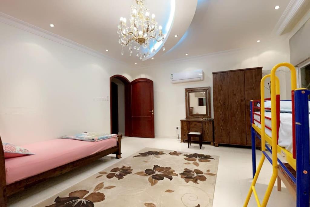 a bedroom with two bunk beds and a chandelier at The luxury Home in Abha