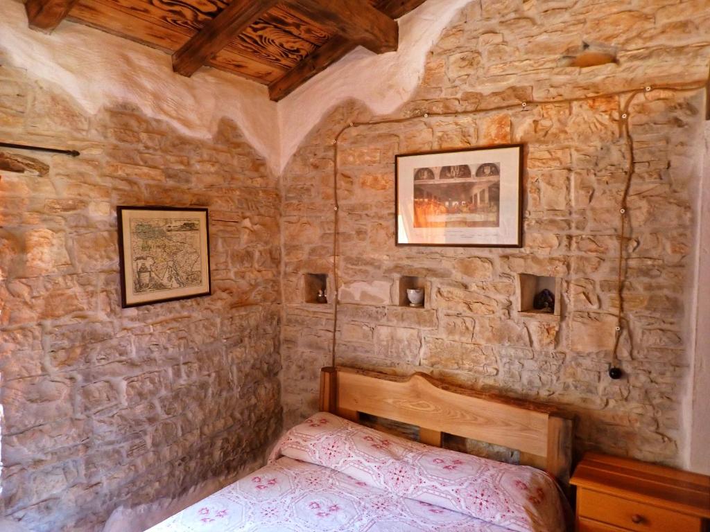 Łóżko lub łóżka w pokoju w obiekcie Cottage al Merlo Olivo