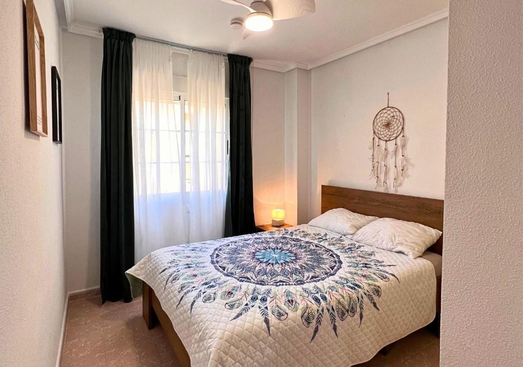 1 dormitorio con 1 cama con edredón en Apartament Blanca, en La Mata