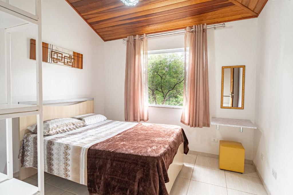 1 dormitorio con cama y ventana en Casa Descanso Paraty en Parati