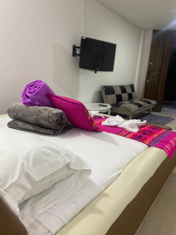 a bed with blankets and pillows on top of it at Mi Balconcito in Salento