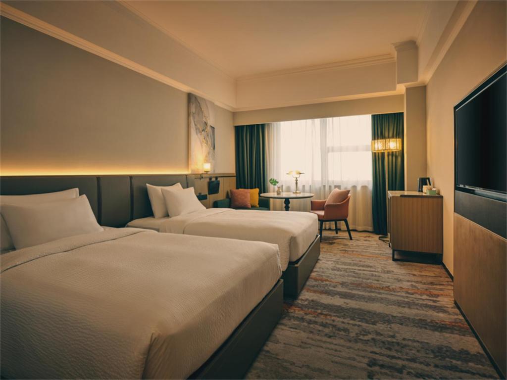 Postel nebo postele na pokoji v ubytování Wanda Yi Hotel Wuxi
