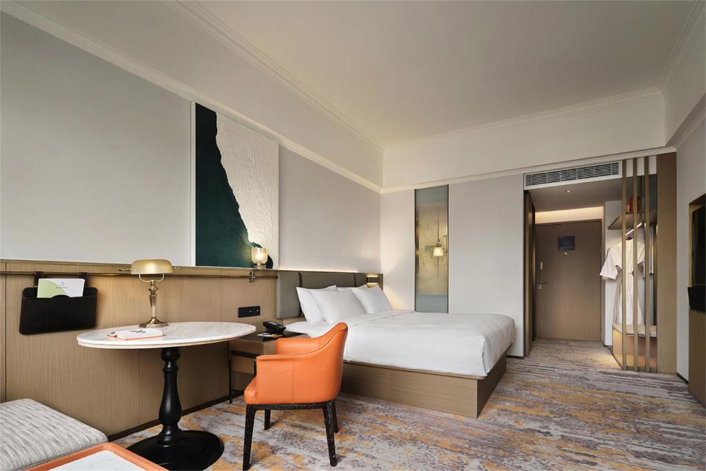 Postel nebo postele na pokoji v ubytování Wanda Yi Hotel Wuxi