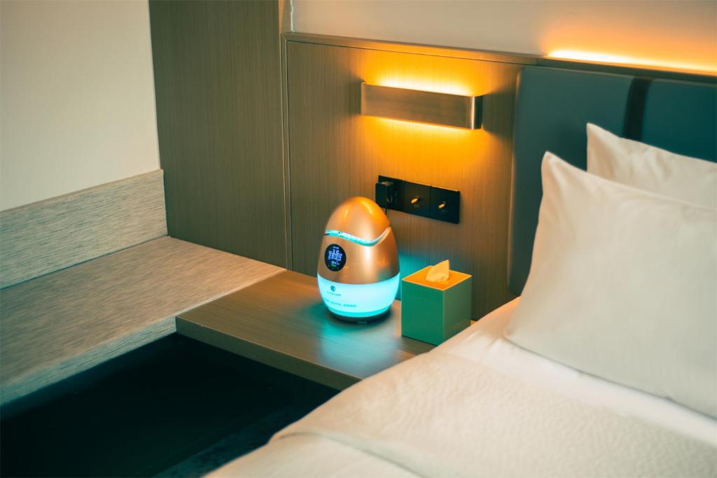 Postel nebo postele na pokoji v ubytování Wanda Yi Hotel Wuxi