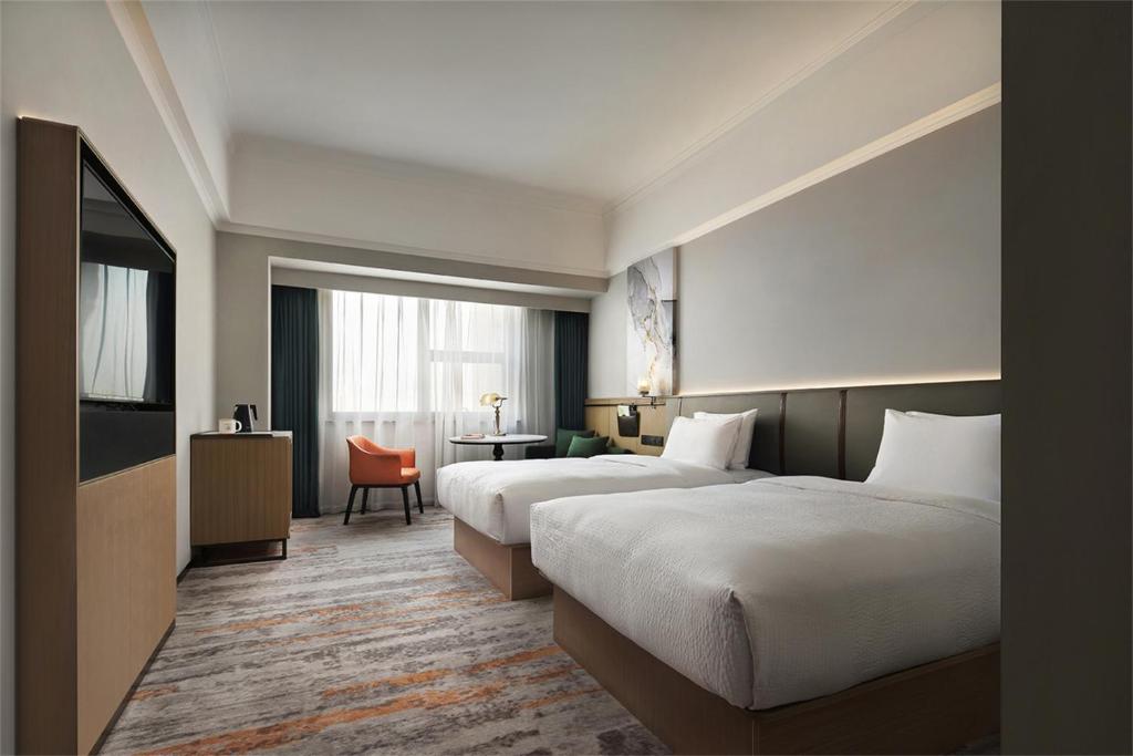 Postel nebo postele na pokoji v ubytování Wanda Yi Hotel Wuxi