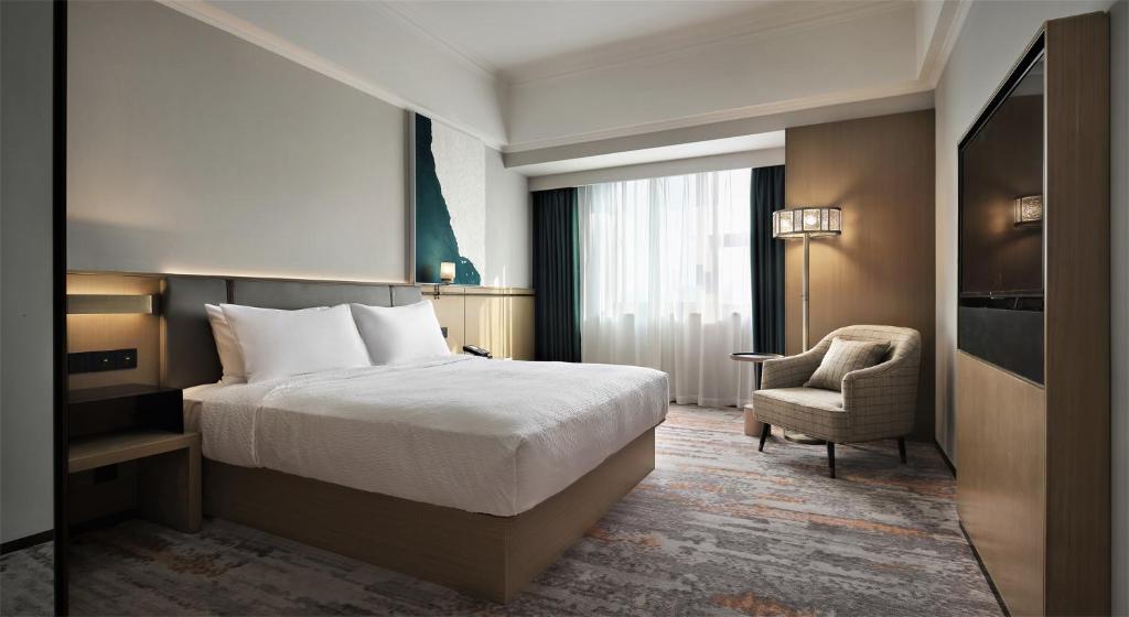 Postel nebo postele na pokoji v ubytování Wanda Yi Hotel Wuxi