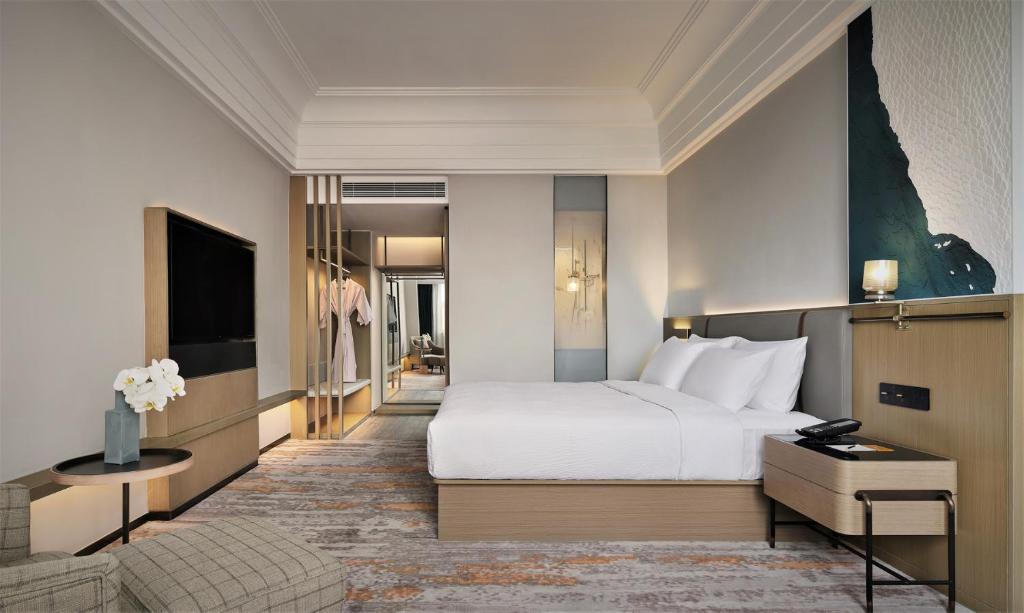 Postel nebo postele na pokoji v ubytování Wanda Yi Hotel Wuxi