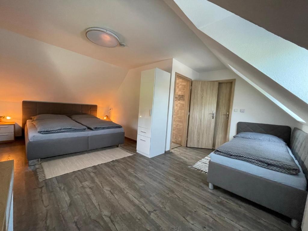 a bedroom with two beds in a attic at Chalupa Soběšice - kraj Šumavy in Soběšice