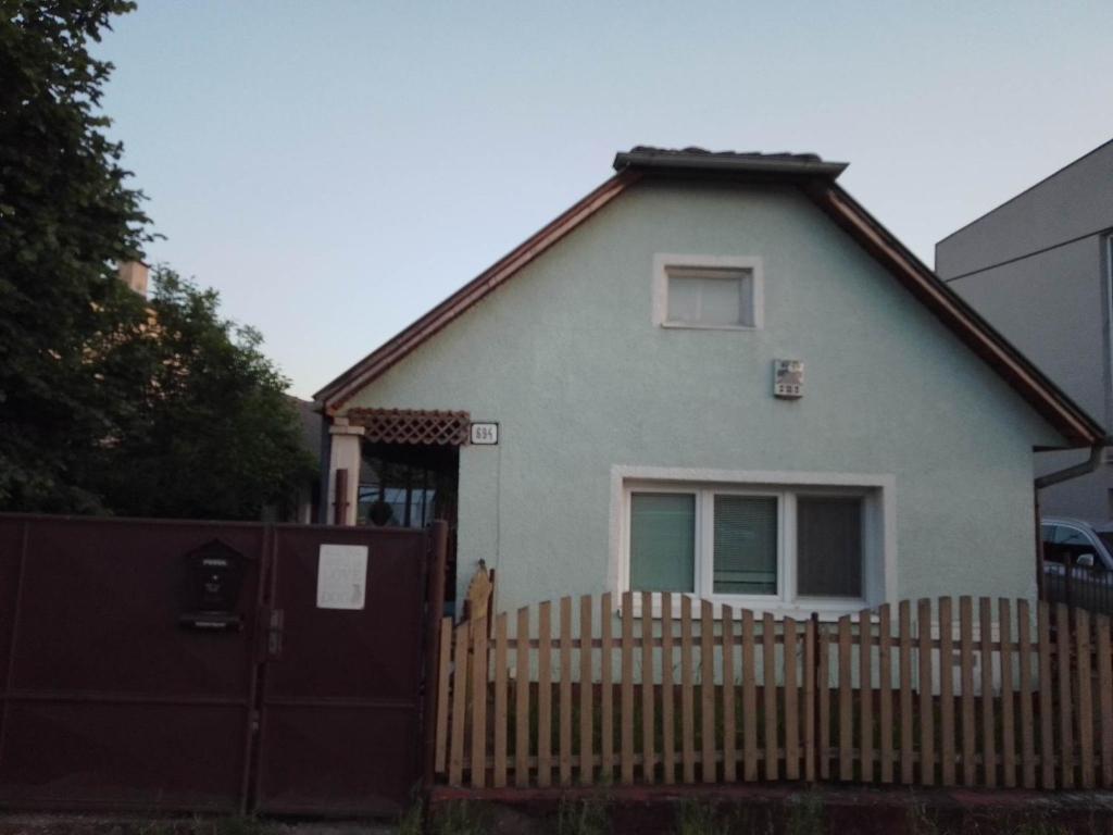 a blue house with a fence and a gate at Domček v Turnej in Trenčianska Turná