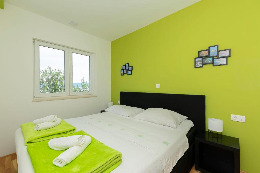Postel nebo postele na pokoji v ubytování Apartments Djani