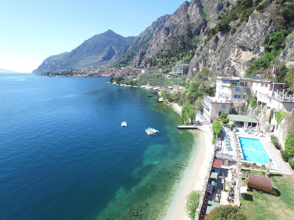 an aerial view of a beach next to the ocean at Villa Romantica Hotel in Limone sul Garda